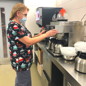 Image of Cindy Coates making coffee in the HJ McFarland Memorial Home kitchen.