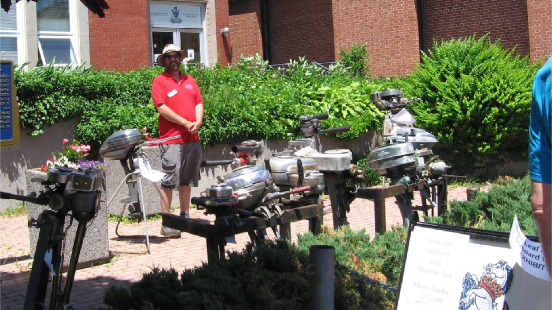 Antique outboard motors on display in front of the Naval Marine Archives