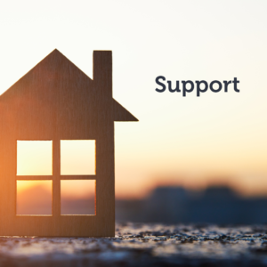 Wooden house with the sun setting behind it with text saying "support"